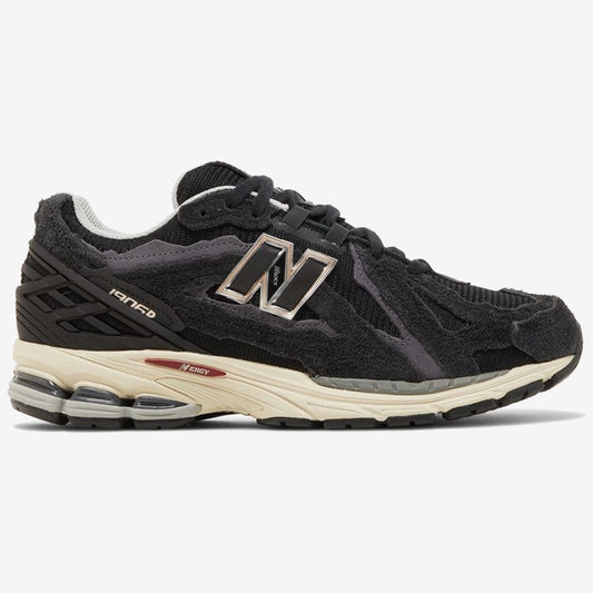 New Balance 1906D noire à semelle crème et logo N clair, vue de profil